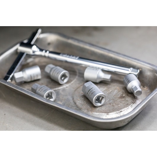 STANLEY STHT81577-0 socket wrench set with five sockets in metal tray, angled view.