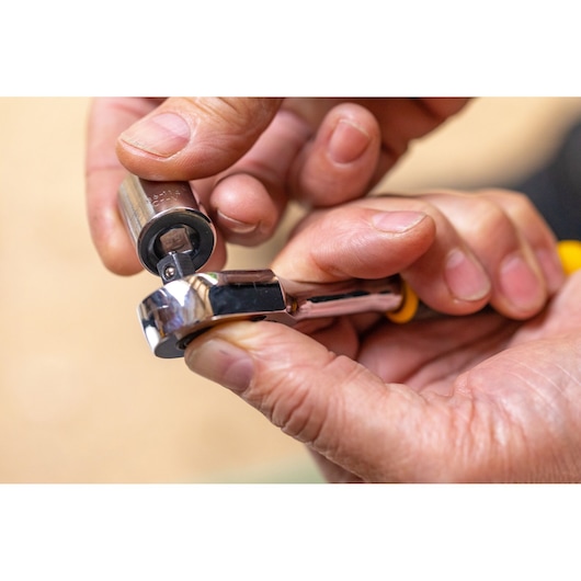 STANLEY STMT82670-0 ratchet wrench with socket, close-up hand assembly, photography.