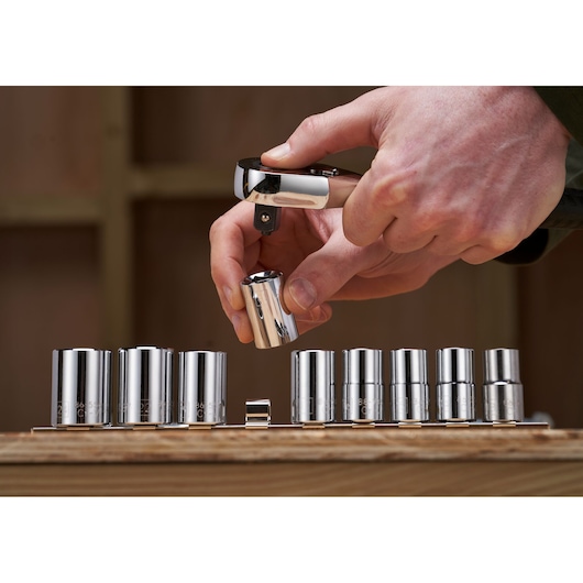 STANLEY STMT82671-0 socket set, photography showing hand fitting chrome socket on ratchet.