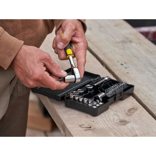 STANLEY STMT82672-0 ratchet and socket set with accessories, 37 pieces, in use outdoors.