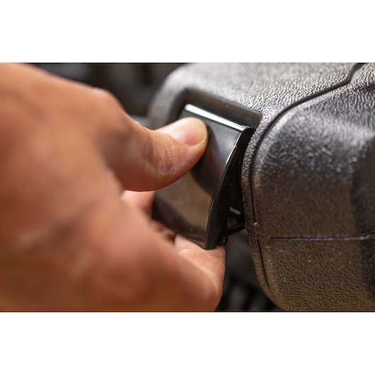 Close-up photo of hand pressing latch on STANLEY STMT82828-1 photography case.