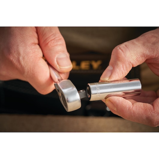 Photo of STANLEY STMT86095-0 socket and ratchet tool being held in hand, close-up detail.
