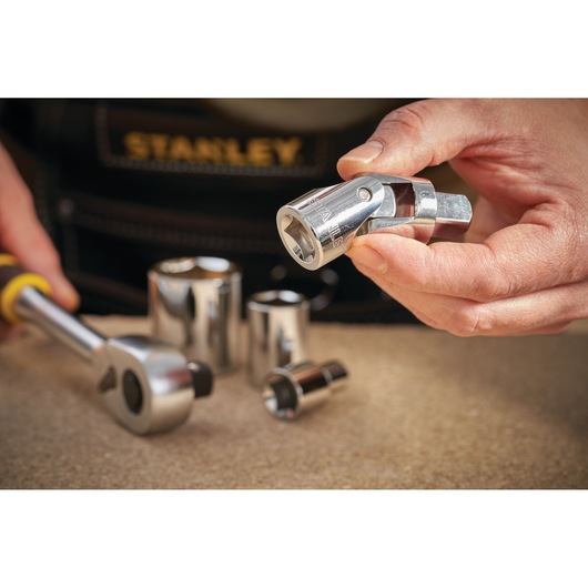 STANLEY STMT86411-0 socket universal joint and ratchet with chrome finish on workbench, photography close-up.
