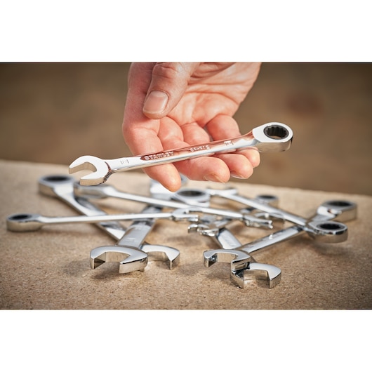 Photo of STANLEY STMT89909-0 ratcheting wrench held in hand with several more on a work surface.