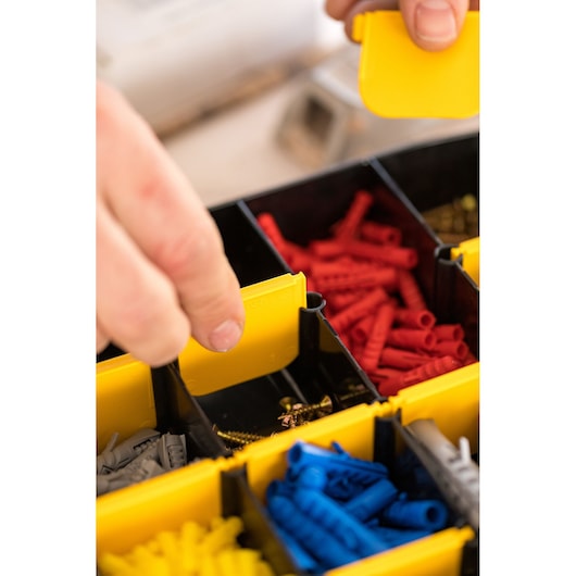 STANLEY STST81681-1 organizer box with yellow dividers, assorted red, blue, yellow anchors and screws, close-up photography.