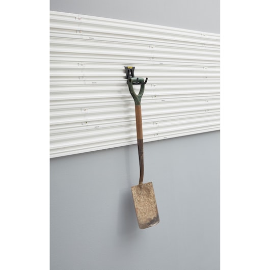 Photo of STANLEY STST82607-1 wall panel with metal garden spade hanging on storage hook, front view.
