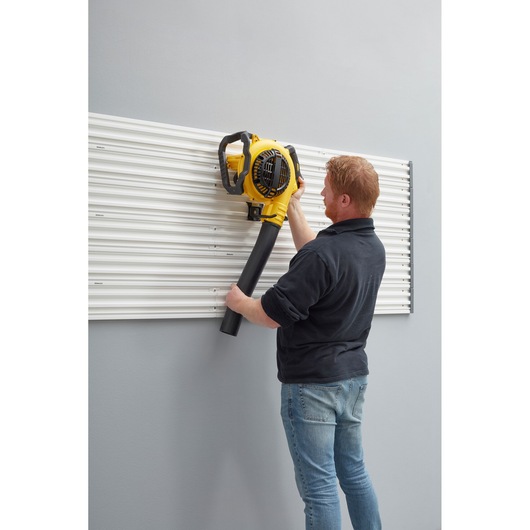 STANLEY STST82609-1 photography of wall panel used to hang a yellow leaf blower.