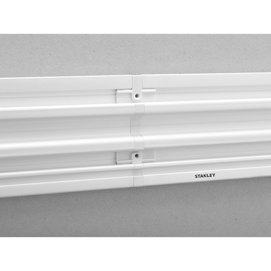 STANLEY STST82610-1 white wall-mounted rail system, close-up angle, three horizontal rails.