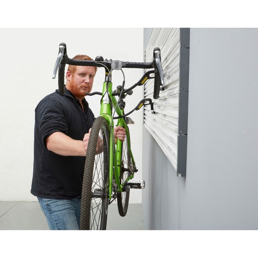 STANLEY STST82615-1 photography of a green bike mounted on wall hooks in a garage setting.