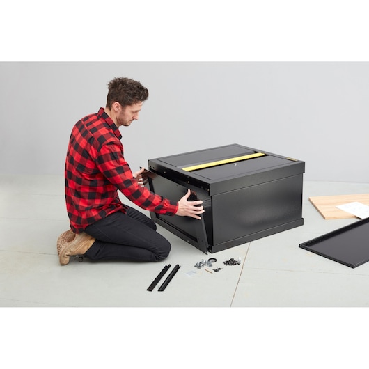 STANLEY STST97595-1 black tool chest assembly in progress with hardware and panels on floor.