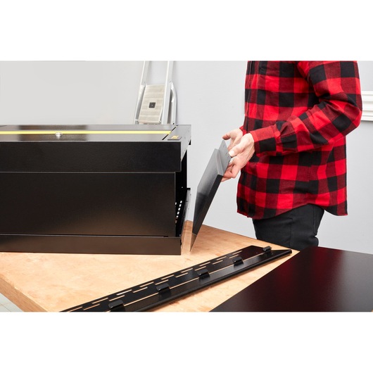 STANLEY STST97598-1 toolbox assembly photo, black steel panels on workbench, side view.